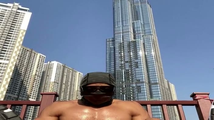 The figure returns upright, with the skyline held behind the shoulders.